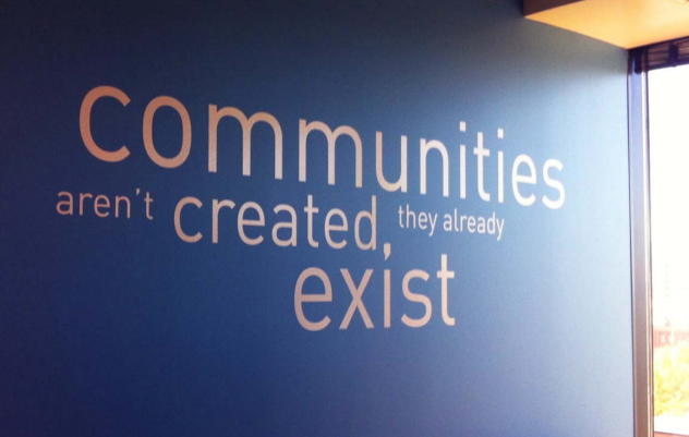 A wall mural at Deseret Digital Media emphasizes the right way to think about online community building.